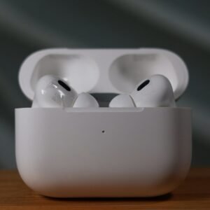 White wireless earbuds in an open charging case.